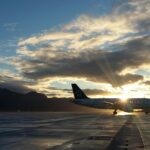 silhouette of airplane in golden hour