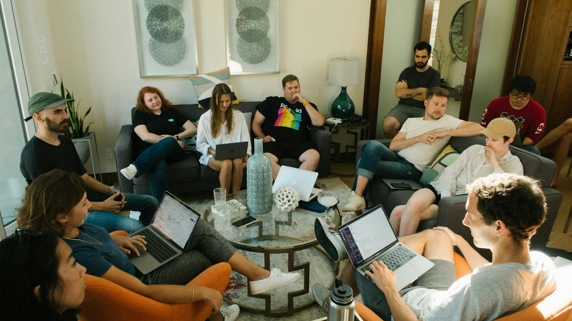 group of people sitting on sofa while discussing